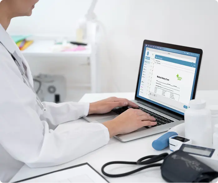 Healthcare professional working on laptop